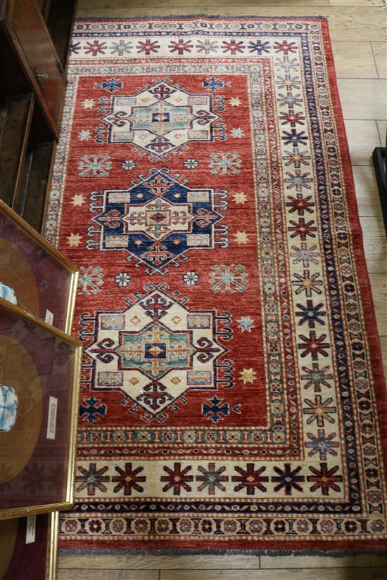 A Hamadan red ground rug, 241cm x 155cm